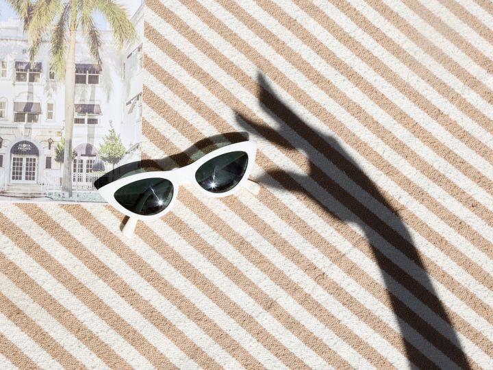 sunglasses on a striped beach towel