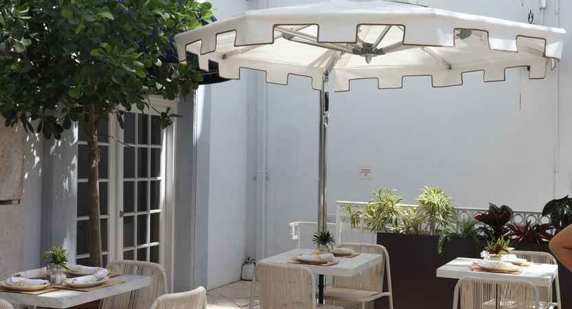 tables under an umbrella on the Honey’s terrace