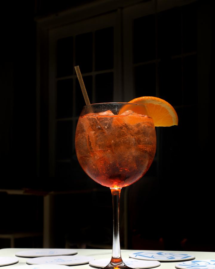 an orange spritz with a straw