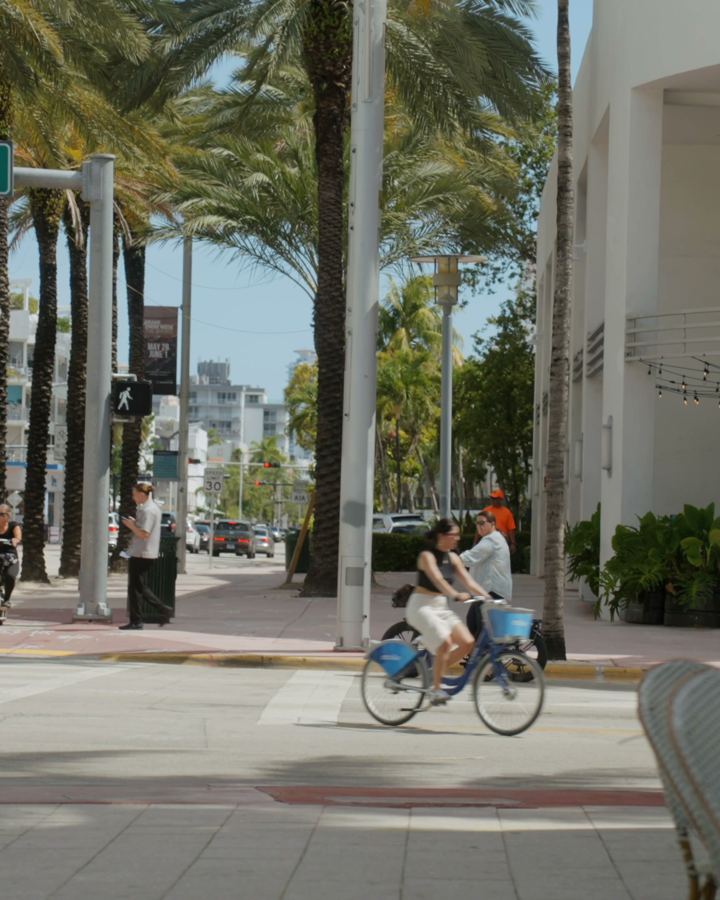 cyclists and cafe tables on Collins Avenue