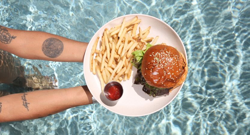 a burger and fries served poolside