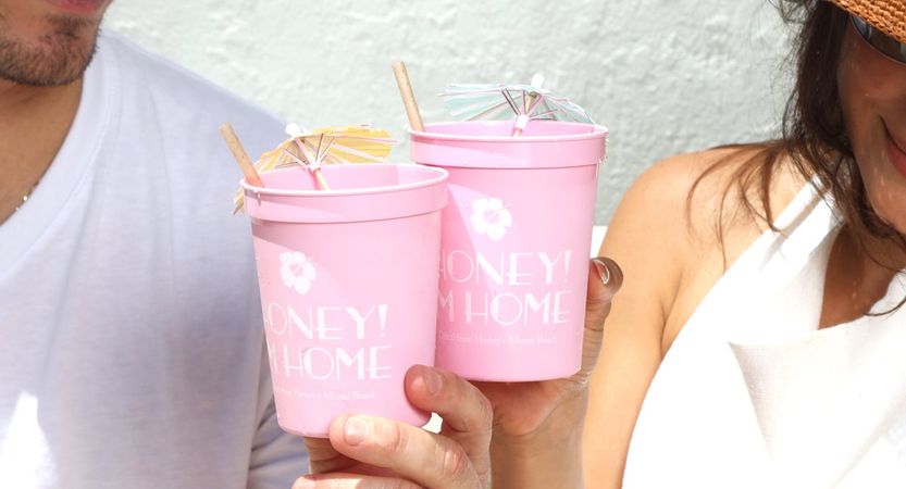 friends toasting with pink Honey’s cups