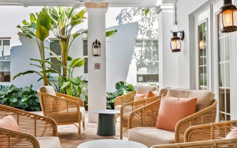 the covered patio with rattan lounge chairs