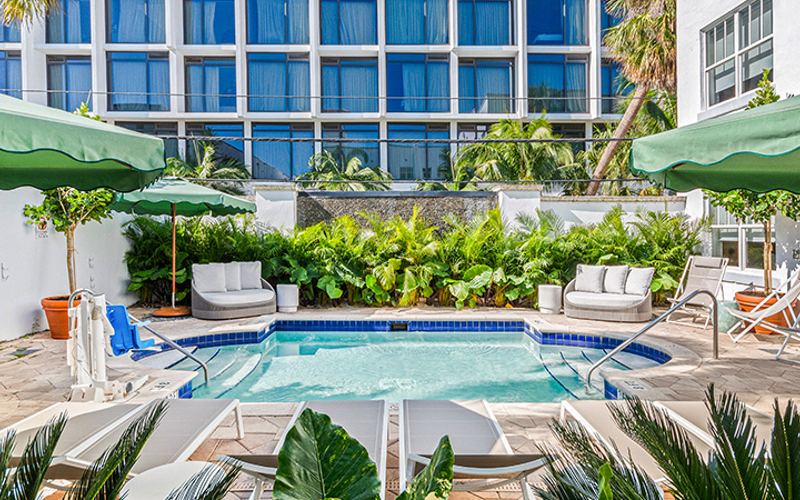 the courtyard pool with green umbrellas and loungers